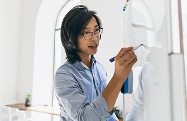 Asian man using whiteboard